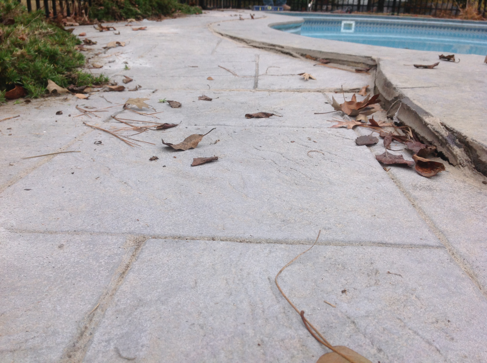 unlevel cracked concrete pool deck - before