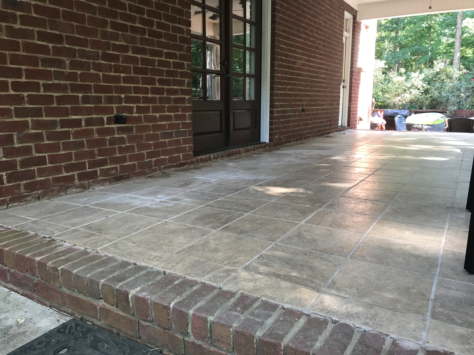 Concrete patio with tile and brick - after
